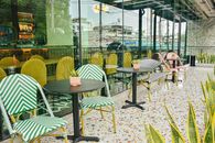 Chic outdoor patio seating with colorful chairs and tables, reflecting a modern design aesthetic.
