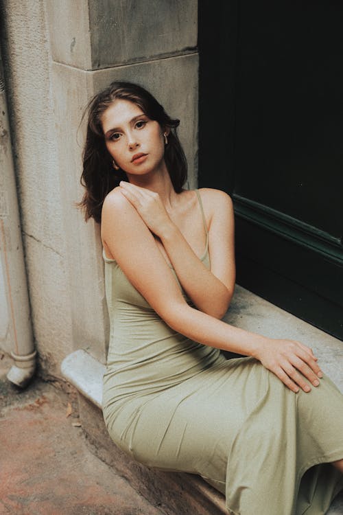 Model Sitting in Green Dress