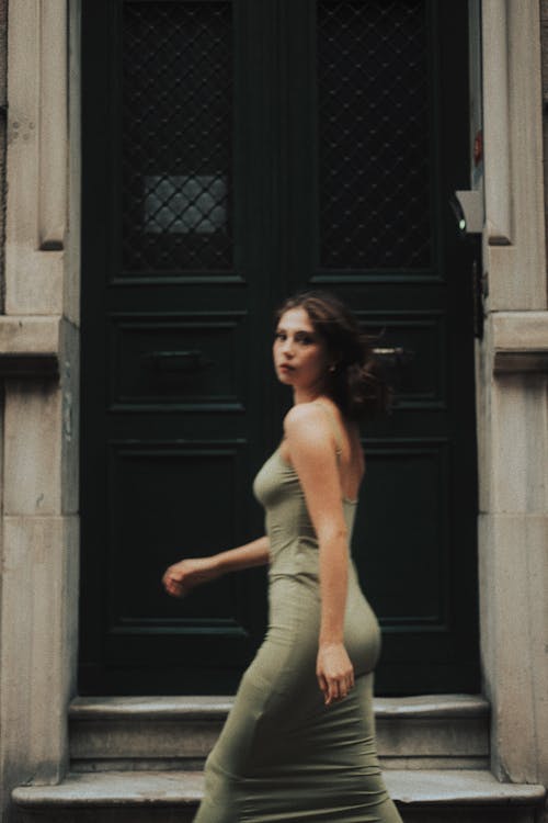 Model in Green Dress Walking by Door