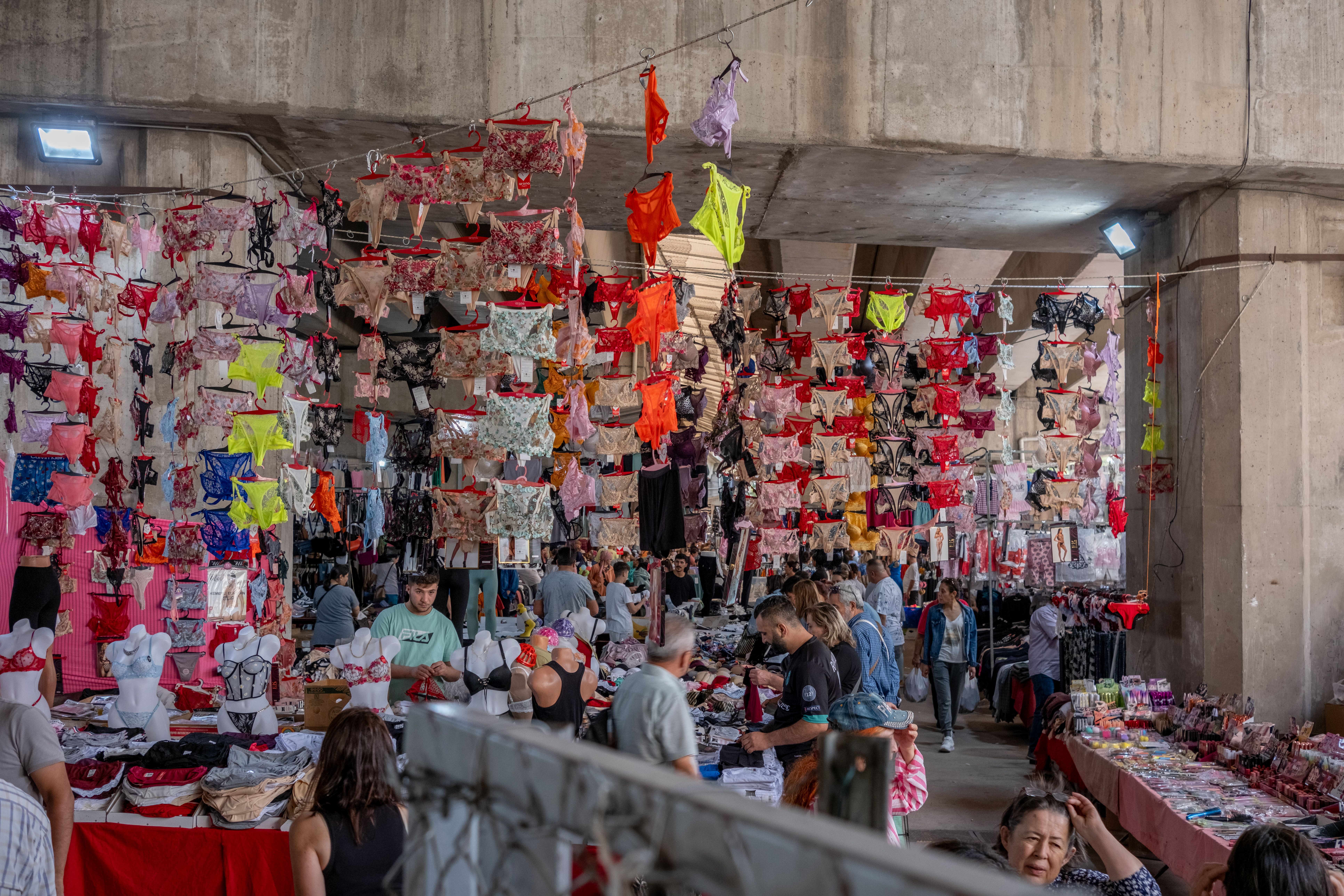 Vibrant indoor market in İzmir, showcasing a diverse selection of underwear.