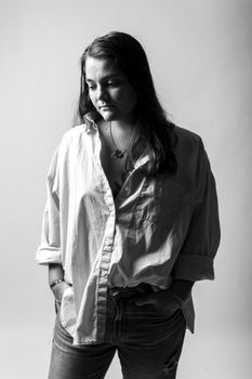 Artistic black and white portrait of a woman in a relaxed pose, symbolizing introspection.