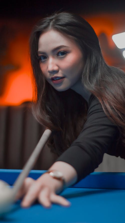 Young Woman Playing Billiards