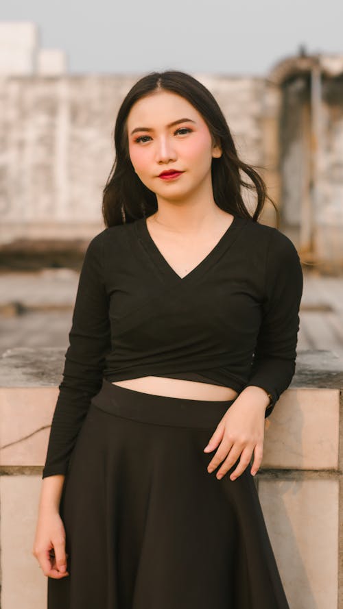 Young Woman in a Black Outfit Posing Outside 