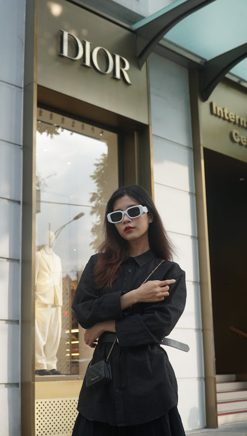 Young Fashionable Woman Standing in front of a Luxury Shop 