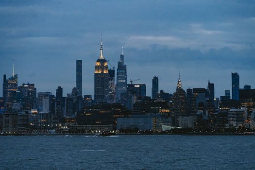 A stunning view of the New York City skyline showcasing famous landmarks at dusk.