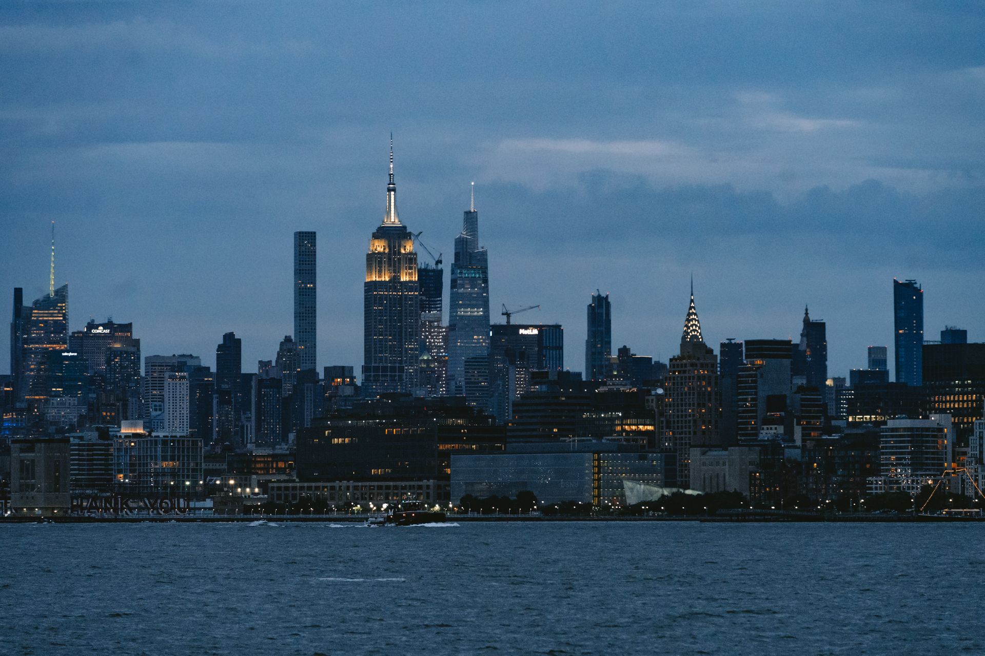 The skyline of new york city is seen at dusk