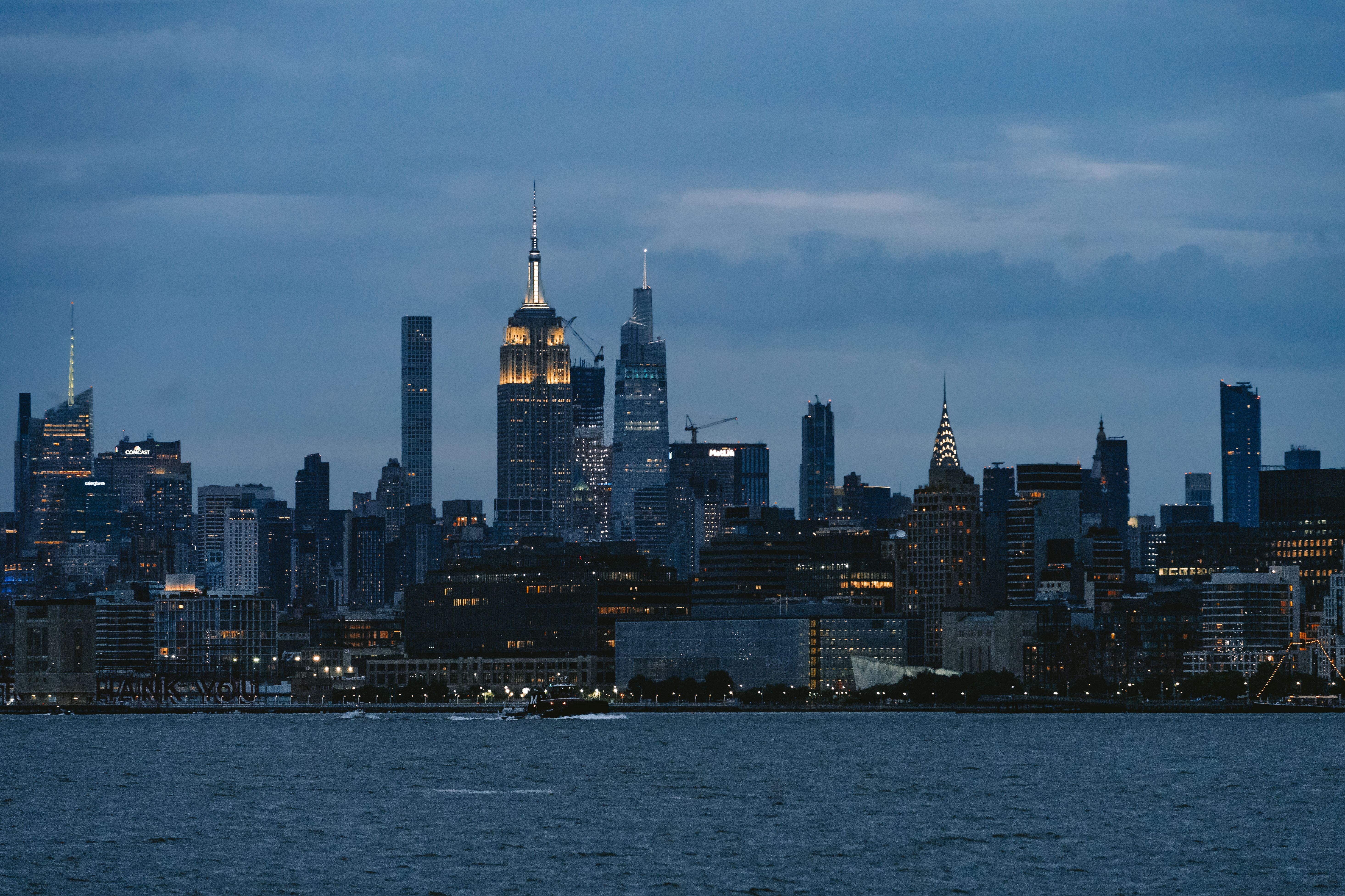 The skyline of new york city is seen at dusk · Free Stock Photo