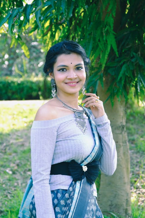 Smiling Brunette in Traditional Earrings and Necklace