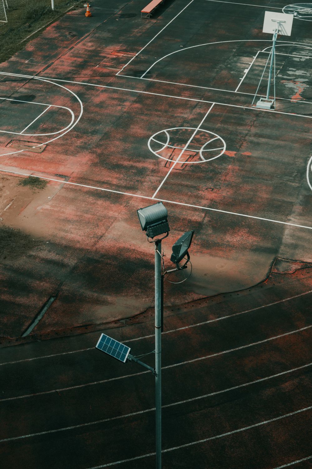 An empty outdoor basketball court at dusk