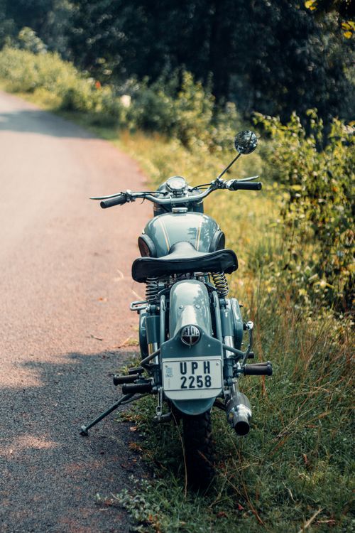 Free A classic motorcycle parked on a rural road in Keonjhar, India. Stock Photo