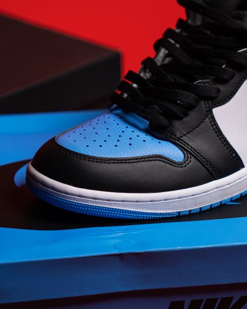 Free Detailed close-up shot of a black and blue sneaker on colorful packaging. Stock Photo