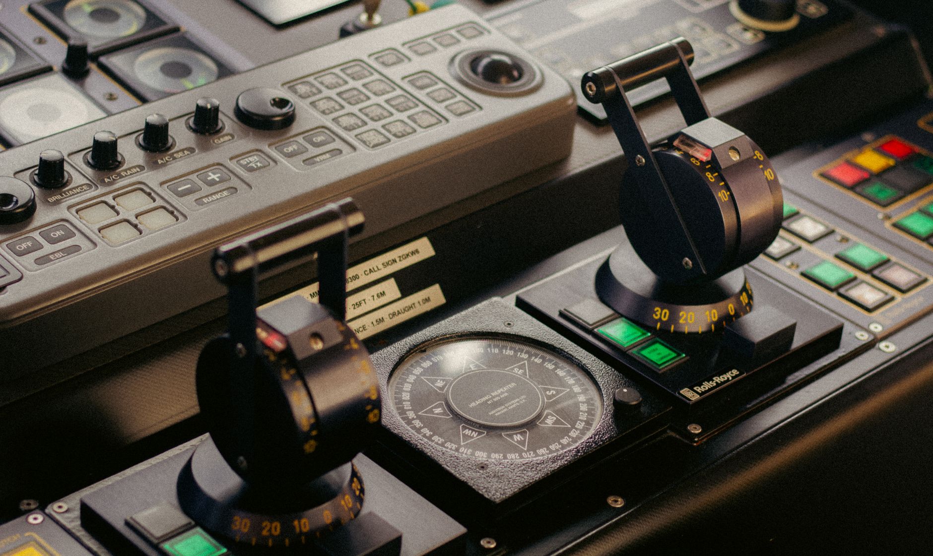 Detailed view of a sophisticated control panel featuring levers, buttons, and compass.