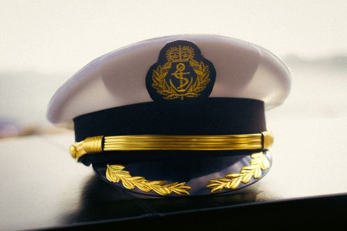 Free Close-up of a captain's hat displaying intricate gold embroidery, symbolizing authority. Stock Photo