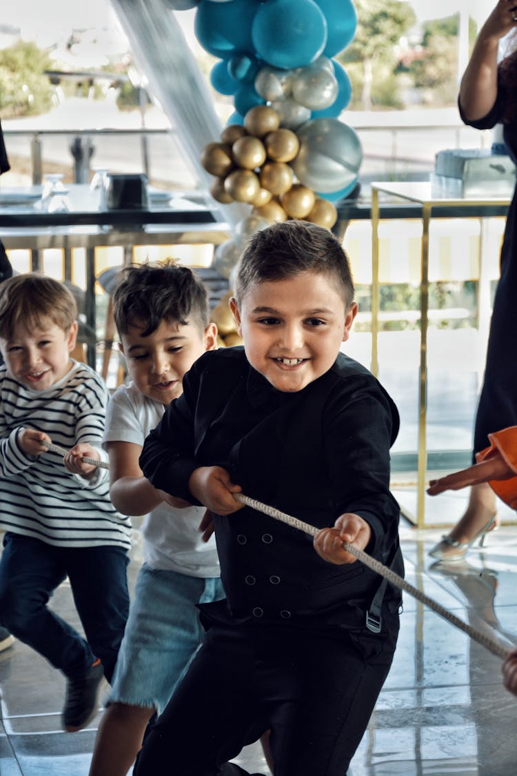 Kids Playing Tug Of War At A Birthday Party 