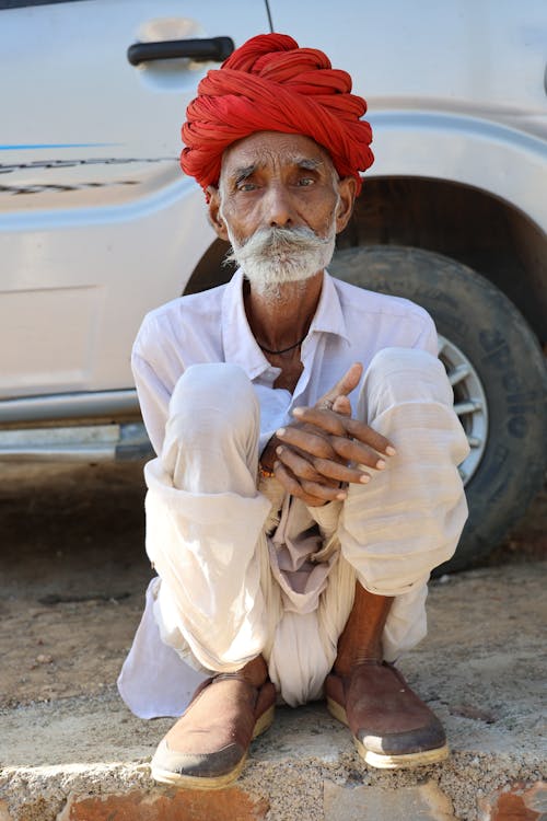 Ederly Man in a Red Turban by the Car