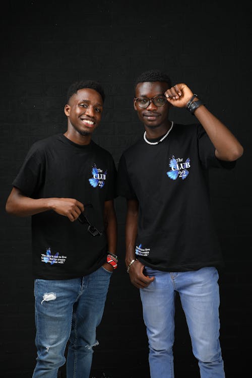 Studio Shot of Two Young Men in Black T-shirts and Jeans 