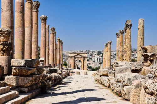 Free Explore the ancient Roman ruins of Jerash, with sunlit columns and historic architecture. Stock Photo