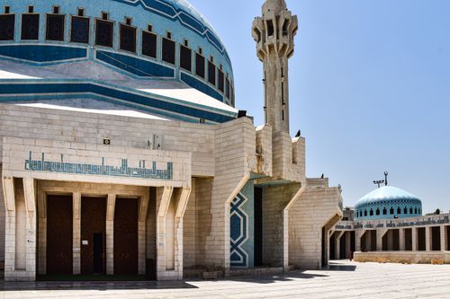 Free The beautiful architecture of King Abdullah I Mosque in Amman, featuring intricate designs and a towering minaret. Stock Photo