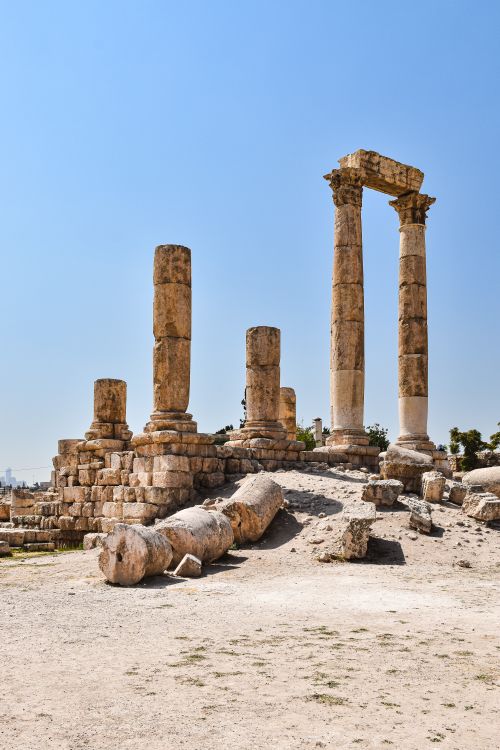 Free Ancient ruins of the Temple of Hercules at Amman Citadel under a clear blue sky. Stock Photo