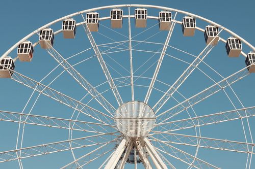 Free Close-up of a Ferris wheel under a clear sky in Alghero, Sardinia, Italy. Stock Photo