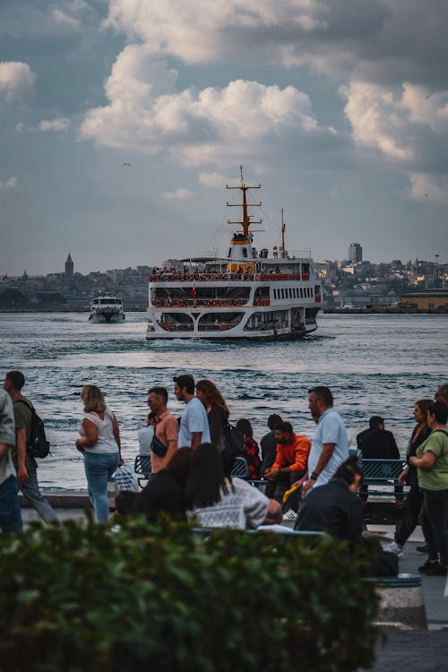 People on the Promenade Along the Strait on Which the Ferries Runs