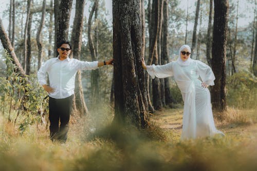 Couple in White Shirt and Abaya Posing in Forest