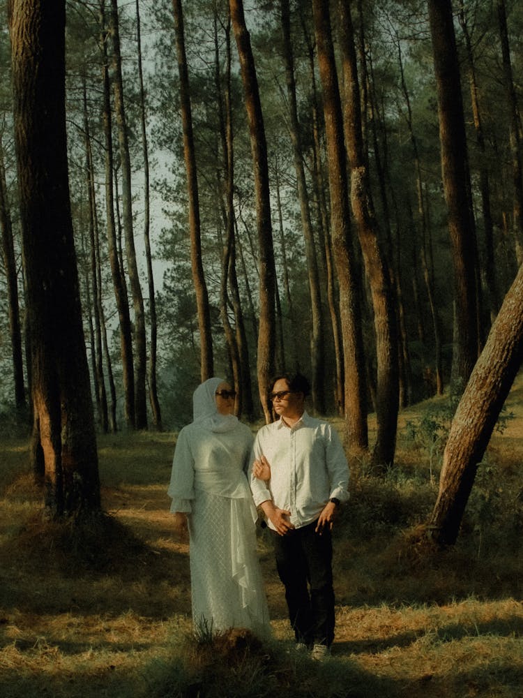 Couple In White Abaya And Shirt Standing Together In Forest