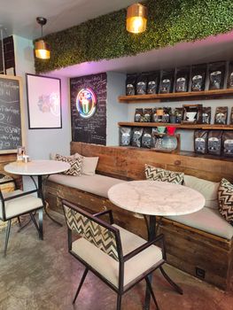Chic café interior featuring cozy seating, modern design, and coffee bean display.