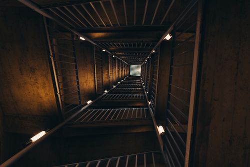 Free A captivating view of a dimly lit staircase in an old residential building in Magdeburg, Germany. Stock Photo