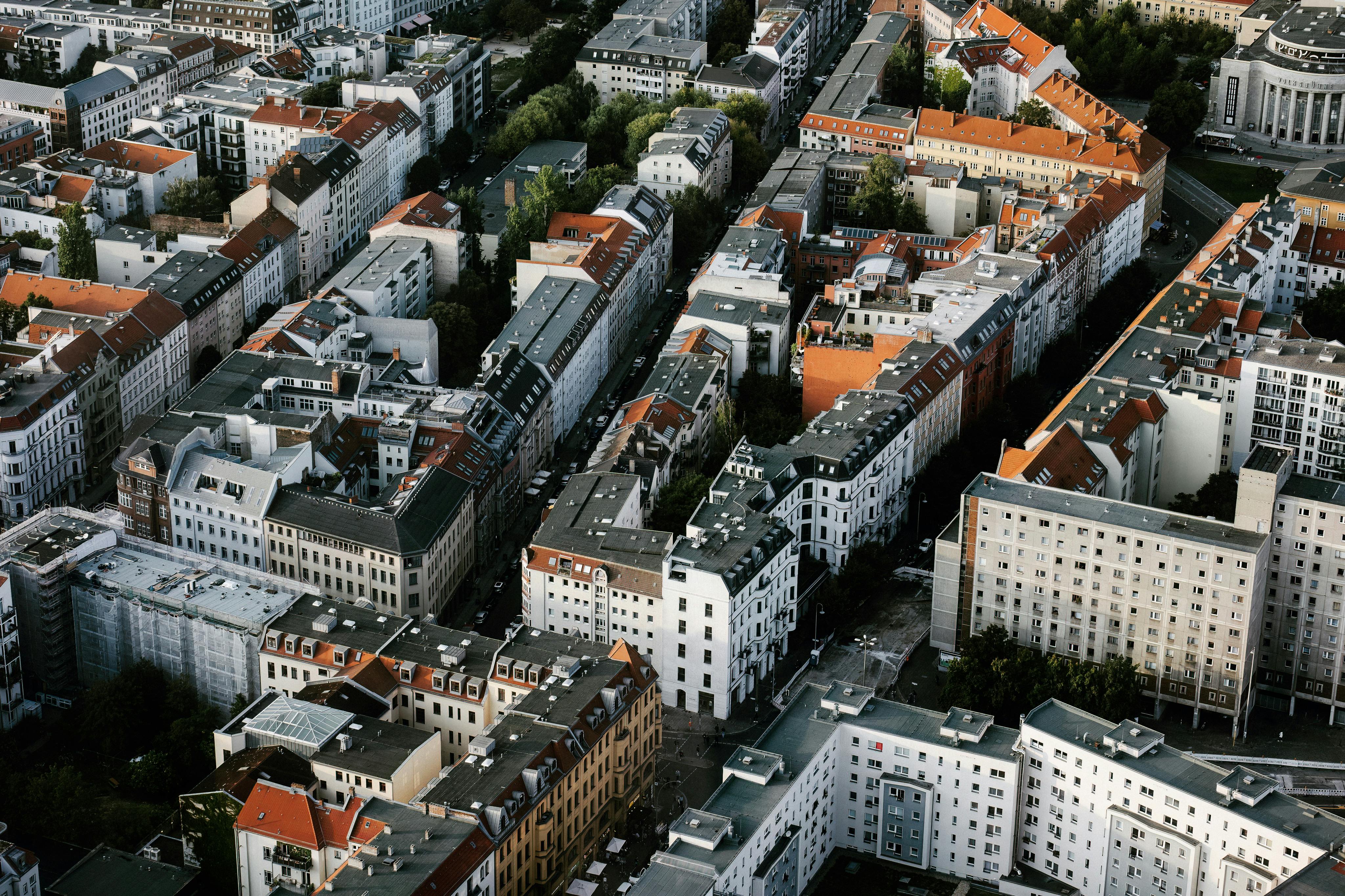 Drone shot showcasing the unique architecture and red rooftops of Berlin, Germany's urban landscape.