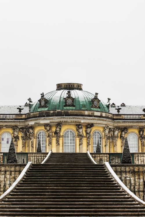 Free Explore the majestic Sanssouci Palace covered in snow, showcasing its baroque architecture. Stock Photo