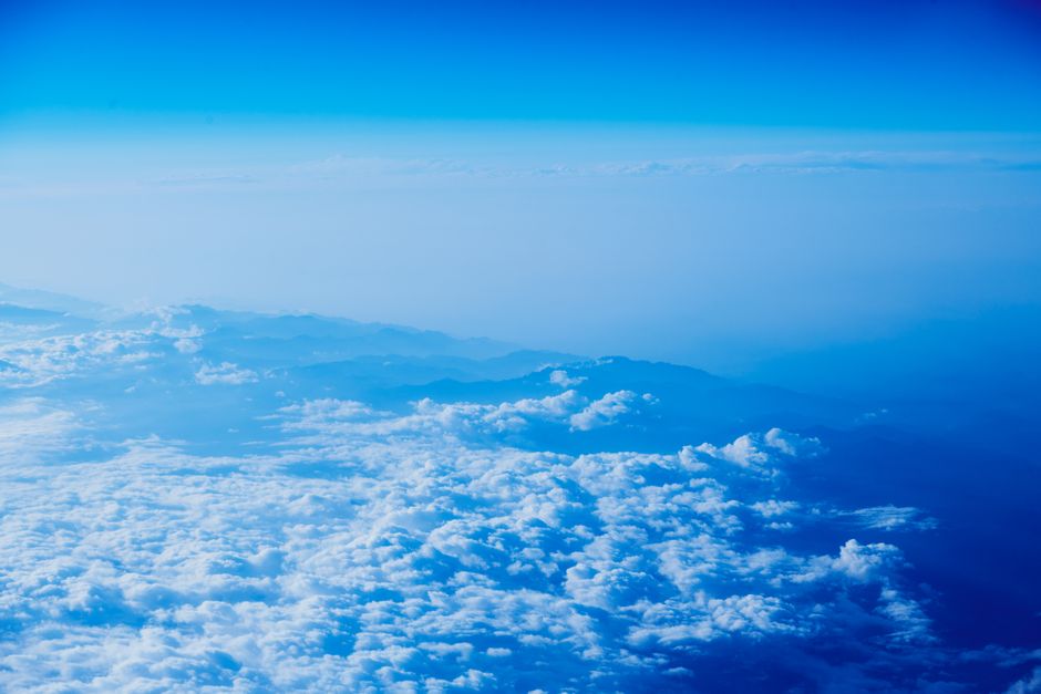 Stunning aerial view of fluffy clouds and blue sky from a high altitude perspective.