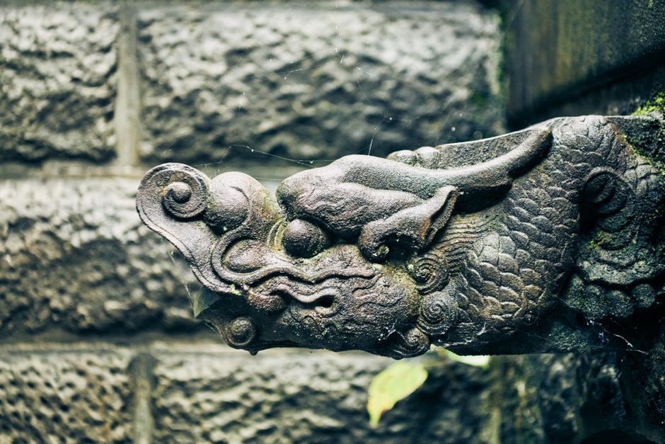 Close-up of an intricately carved stone Chinese dragon ornament, highlighting cultural heritage.