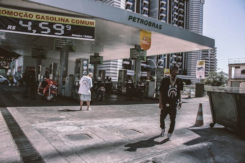 Free Man Walking Behind Petrobras Gasoline Station Stock Photo