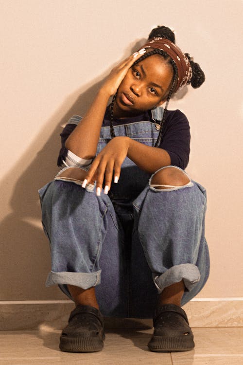 African Woman Posing in Denim Dungarees 