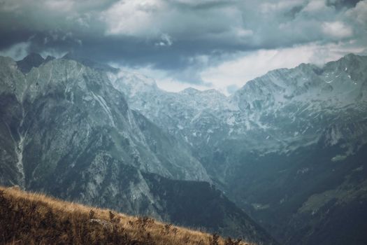 A breathtaking view of a cloudy mountain range with dramatic skies.