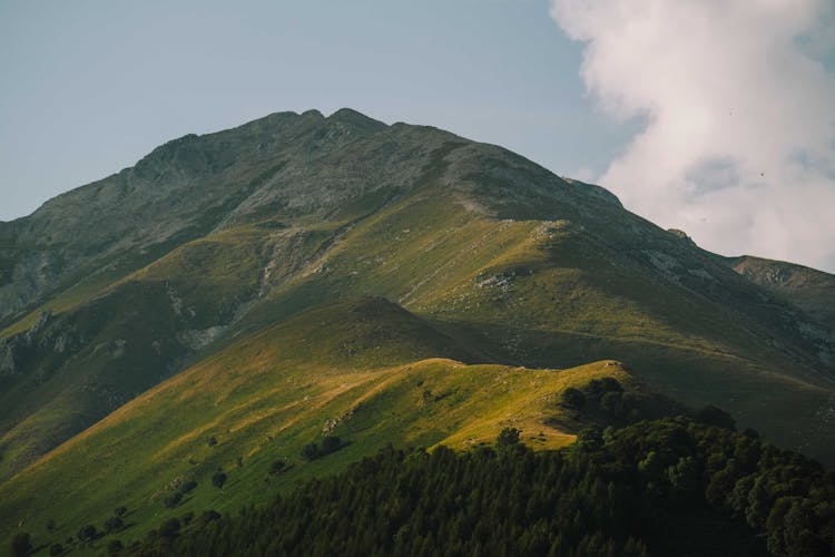 Mountain And Green Hills With Forest Trees Below 