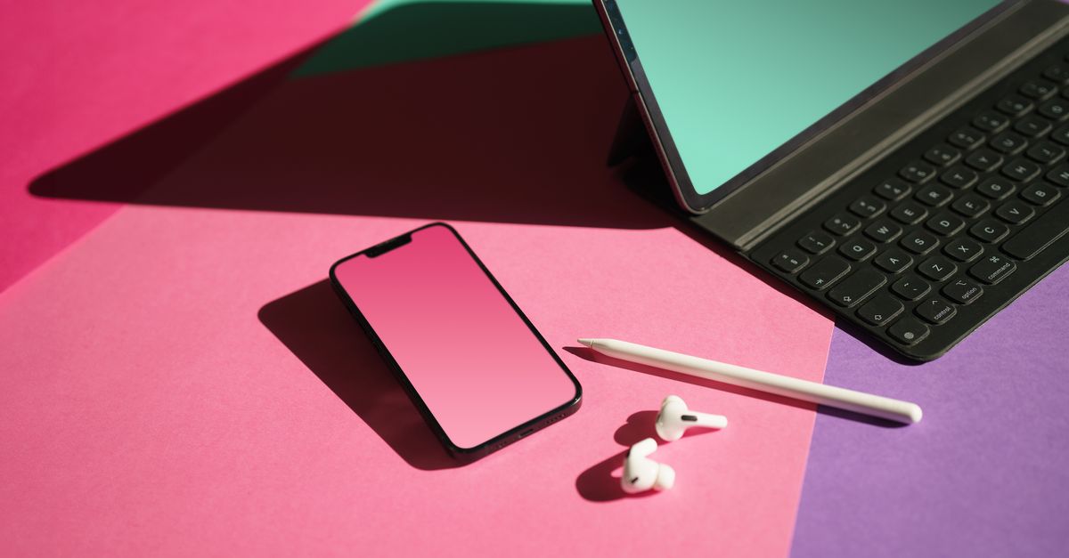 Stylus Pen Earpods and Smartphone by Laptop on Desk · Free Stock Photo