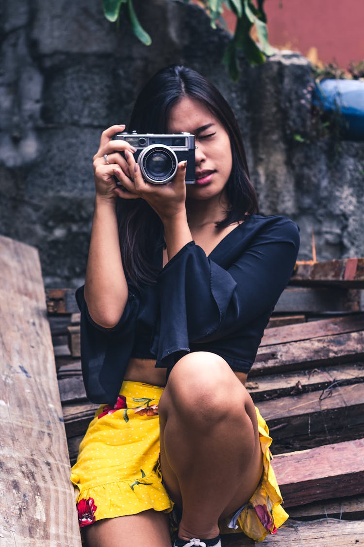 Woman Taking Photo Using SLR Camera