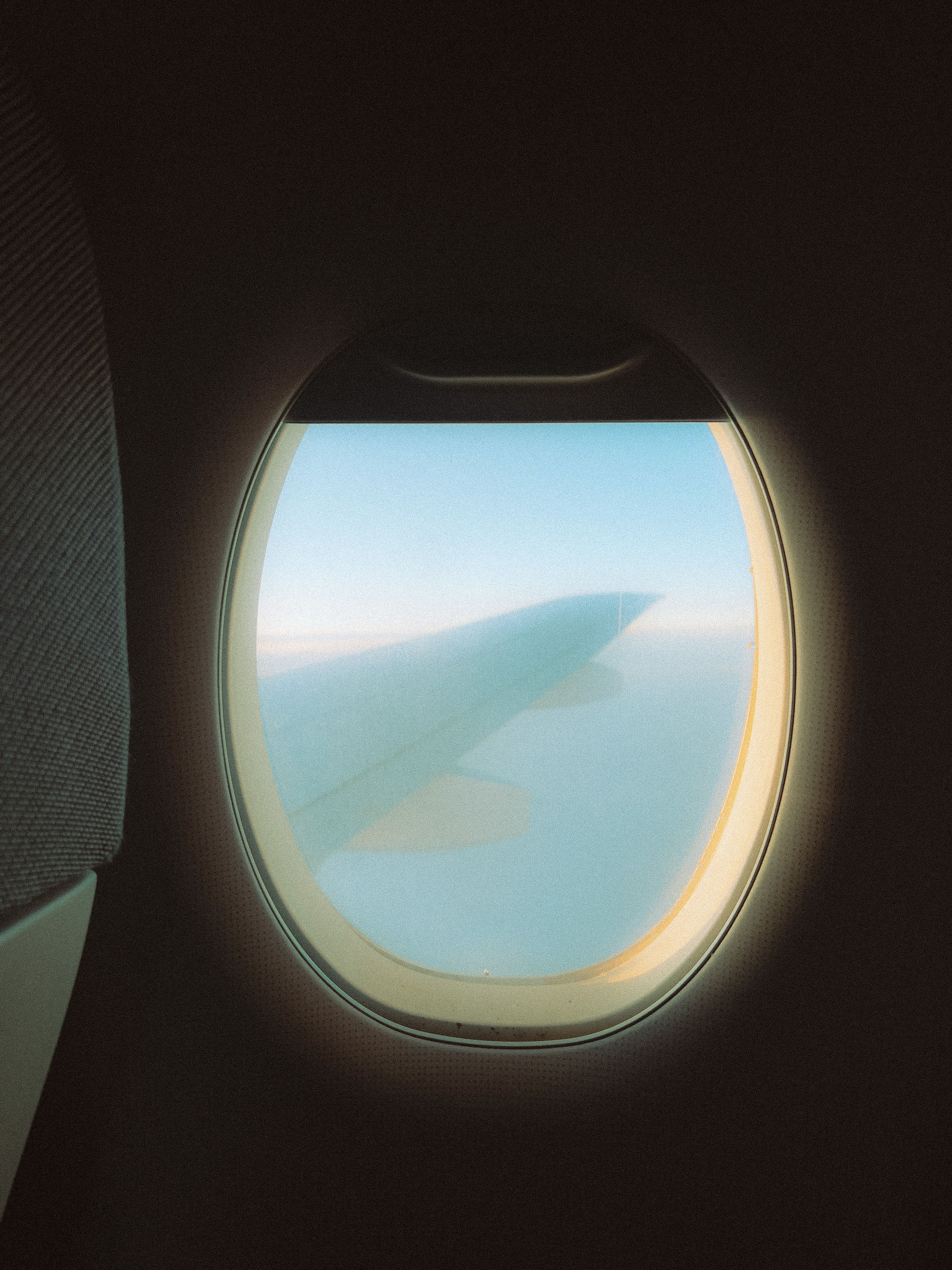 Airplane Wing behind Window during Flight · Free Stock Photo