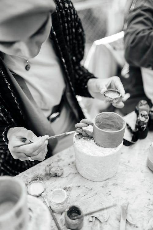 Woman Decorating Clay Cup