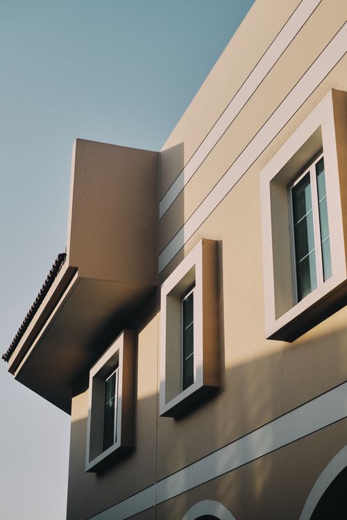 Free Low angle view of modern architecture with clear sky in Dubai, showcasing unique window design. Stock Photo