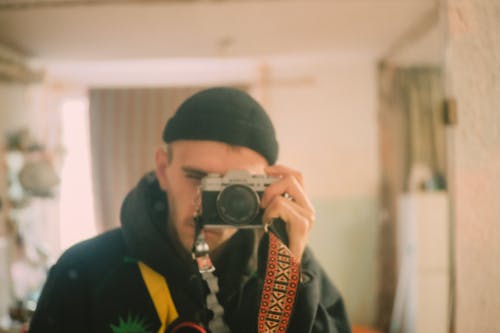 Man Taking a Photo of Himself in the Mirror