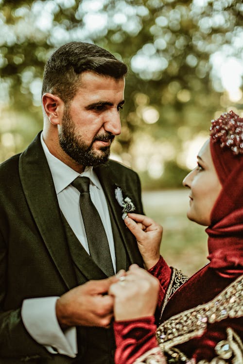 Bride and Groom Standing Outside and Looking at Each Other 