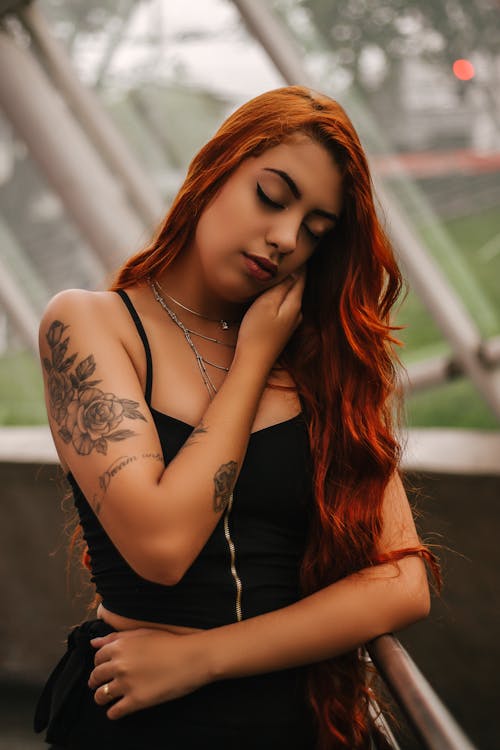 Woman Wearing Tank Top While Closing Her Eyes