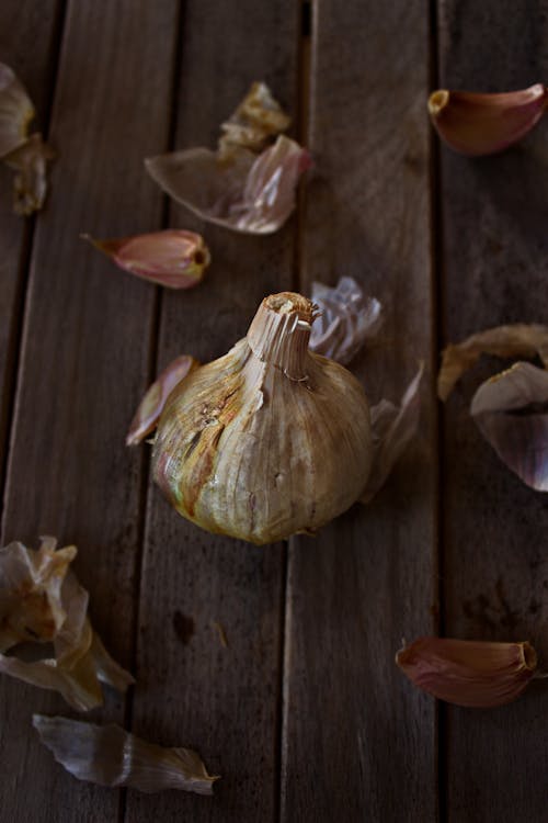 Raw Garlic Lying on a Wooden Surface