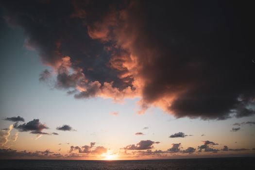 Captivating sunset over Santa Cruz de La Palma's ocean with dramatic storm clouds.