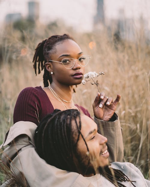 Free Man and Woman Surrounded by Grass Stock Photo