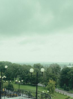 Scenic aerial view of a lush green park in Mogilev, Belarus, featuring pathways and lampposts.