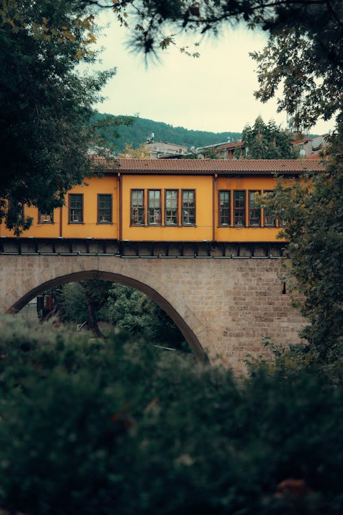 Yellow Building on Bridge in Town